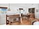 Cozy dining area with wicker furniture and light hardwood floors, accented by natural light at 7420 Manasota Key Rd, Englewood, FL 34223