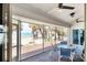 Relaxing screened lanai with comfortable seating and views of the beach and surrounding palm trees at 7420 Manasota Key Rd, Englewood, FL 34223