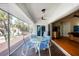Screened-in porch with an outdoor dining table and chairs, with access to the living room at 7420 Manasota Key Rd, Englewood, FL 34223