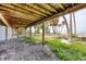 Underneath the deck with supports and posts that leads to a sandy beach lined with palm trees at 7420 Manasota Key Rd, Englewood, FL 34223