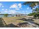Spacious backyard with a boat dock and lift, offering direct access to the waterfront at 7530 Whitcomb St, Englewood, FL 34223