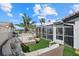 A screened-in pool and patio with lounge seating create a perfect outdoor oasis at 7530 Whitcomb St, Englewood, FL 34223
