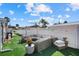 Inviting backyard features comfortable lounge seating and low-maintenance artificial grass at 7530 Whitcomb St, Englewood, FL 34223