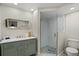 Elegant bathroom featuring a marble vanity, gold fixtures, and a glass-enclosed shower at 7530 Whitcomb St, Englewood, FL 34223