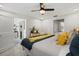 Bright bedroom with ceiling fan, comfortable bed, and en suite bathroom access at 7530 Whitcomb St, Englewood, FL 34223