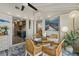 Cozy dining area with open access to kitchen and bedroom, featuring a turtle painting and natural lighting at 7530 Whitcomb St, Englewood, FL 34223