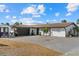 Charming single-story home with a tile roof and an expansive paved driveway at 7530 Whitcomb St, Englewood, FL 34223
