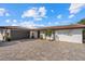 Charming single-story home with a tile roof and an expansive paved driveway at 7530 Whitcomb St, Englewood, FL 34223