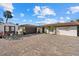 Charming single-story home with a tile roof, paved driveway, and additional parking at 7530 Whitcomb St, Englewood, FL 34223