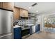 Modern kitchen showcasing stainless steel appliances, custom cabinetry, and a stylish backsplash with breakfast nook beyond at 7530 Whitcomb St, Englewood, FL 34223