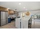 Bright kitchen boasts stainless steel appliances, a large island with seating, and stylish decor with outdoor views at 7530 Whitcomb St, Englewood, FL 34223
