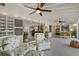 Open concept living room with multiple seating areas, and a kitchen and dining area at 7530 Whitcomb St, Englewood, FL 34223