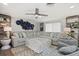 Comfortable living room with plush seating, stylish decor, and a ceiling fan for added comfort at 7530 Whitcomb St, Englewood, FL 34223