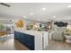 Open living space with kitchen island, comfortable seating, and a view of the pool, perfect for entertaining at 7530 Whitcomb St, Englewood, FL 34223