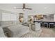Open-concept living area featuring plush seating, stylish decor, and a kitchen island, perfect for gatherings at 7530 Whitcomb St, Englewood, FL 34223