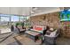 Relaxing outdoor seating area featuring wicker furniture, wood-paneled wall, and serene views of the waterfront at 7530 Whitcomb St, Englewood, FL 34223