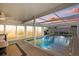 Sunset view of pool area with screened enclosure, poolside bar, and seamless indoor-outdoor flow for entertainment at 7530 Whitcomb St, Englewood, FL 34223