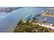 Waterfront condos with marina access; white exteriors, turquoise roofs, lush surroundings at 8005 Bay Pointe Dr, Englewood, FL 34224