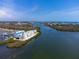 Aerial view of a waterfront condo building complex surrounded by lush mangroves and winding waterways at 8005 Bay Pointe Dr, Englewood, FL 34224