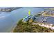Waterfront condos with marina access; white exteriors, turquoise roofs, lush surroundings at 8005 Bay Pointe Dr, Englewood, FL 34224