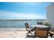 Balcony with dining table and chairs overlooking peaceful waters and beautiful coastline views at 8005 Bay Pointe Dr, Englewood, FL 34224