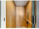 An interior view of a private elevator with wood paneling and a telephone at 8005 Bay Pointe Dr, Englewood, FL 34224
