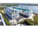 Exterior of waterfront condos surrounded by palms, docks, and beautiful landscaping at 8005 Bay Pointe Dr, Englewood, FL 34224