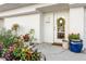 Inviting front entry with a wreath, colorful potted plants, and a freshly painted front door at 8005 Bay Pointe Dr, Englewood, FL 34224