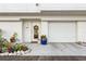 Charming front entrance featuring a decorative wreath, potted plants, and a well-kept garage at 8005 Bay Pointe Dr, Englewood, FL 34224