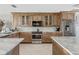 Kitchen featuring custom wood cabinets, stainless steel appliances, and marble countertops at 8005 Bay Pointe Dr, Englewood, FL 34224