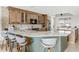 Updated kitchen featuring a marble breakfast bar, custom cabinets, and modern stainless steel appliances at 8005 Bay Pointe Dr, Englewood, FL 34224