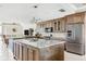 Spacious kitchen with stainless steel appliances, marble countertops, and custom wood cabinetry at 8005 Bay Pointe Dr, Englewood, FL 34224