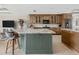 Kitchen with large marble island, stainless steel appliances, and custom wood cabinetry at 8005 Bay Pointe Dr, Englewood, FL 34224