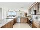 Kitchen featuring custom wood cabinets, stainless steel appliances, and views of the water at 8005 Bay Pointe Dr, Englewood, FL 34224