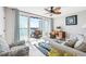 Inviting living room with outdoor balcony access and a ceiling fan at 8005 Bay Pointe Dr, Englewood, FL 34224