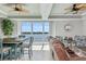 Bright living room with dining table, a view of the water, and comfortable seating arrangements at 8005 Bay Pointe Dr, Englewood, FL 34224