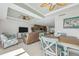 Open-concept living space with a dining table, seating area, kitchen and breakfast bar at 8005 Bay Pointe Dr, Englewood, FL 34224