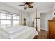 Comfortable main bedroom featuring wood flooring, an ensuite bathroom, and natural light at 8005 Bay Pointe Dr, Englewood, FL 34224