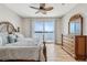 Serene main bedroom with water views, wood floors, and a tropical-style ceiling fan at 8005 Bay Pointe Dr, Englewood, FL 34224