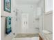 Modern shower with tiled walls, glass door, and dual shower heads at 8005 Bay Pointe Dr, Englewood, FL 34224