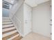 Elegant staircase featuring wood-like tile steps, white railings, and a fresh coat of paint at 8005 Bay Pointe Dr, Englewood, FL 34224