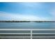 A scenic view from a waterfront balcony showcasing the expansive water and distant shoreline at 8005 Bay Pointe Dr, Englewood, FL 34224
