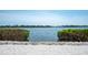 Scenic water view framed by lush greenery and rocky shores, creating a peaceful retreat at 8005 Bay Pointe Dr, Englewood, FL 34224
