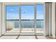 Gorgeous waterfront view through sliding glass doors leads to outdoor seating on the balcony at 8005 Bay Pointe Dr, Englewood, FL 34224
