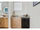 Convenient wet bar has granite countertop, mini fridge, sink, and stylish cabinets at 8005 Bay Pointe Dr, Englewood, FL 34224
