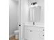 Well-lit bathroom with a white vanity, quartz countertop, modern black fixtures, and a nearby toilet at 8105 Antwerp Cir, Port Charlotte, FL 33981