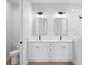 Modern bathroom featuring a double vanity, white cabinetry, quartz countertops, and stylish fixtures at 8105 Antwerp Cir, Port Charlotte, FL 33981