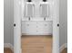 Bright bathroom featuring a double vanity with white cabinets, quartz countertops, and modern fixtures at 8105 Antwerp Cir, Port Charlotte, FL 33981