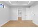Open bedroom boasts wood floors and ensuite bathroom with bright, airy feel at 8105 Antwerp Cir, Port Charlotte, FL 33981