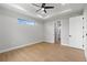Minimalist bedroom with wood floors, modern ceiling fan and ensuite access at 8105 Antwerp Cir, Port Charlotte, FL 33981